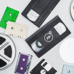 Flat Lay Of Vhs Cassettes Diskettes Cd Discs Film Reels And Colorful Cassettes On White Background
